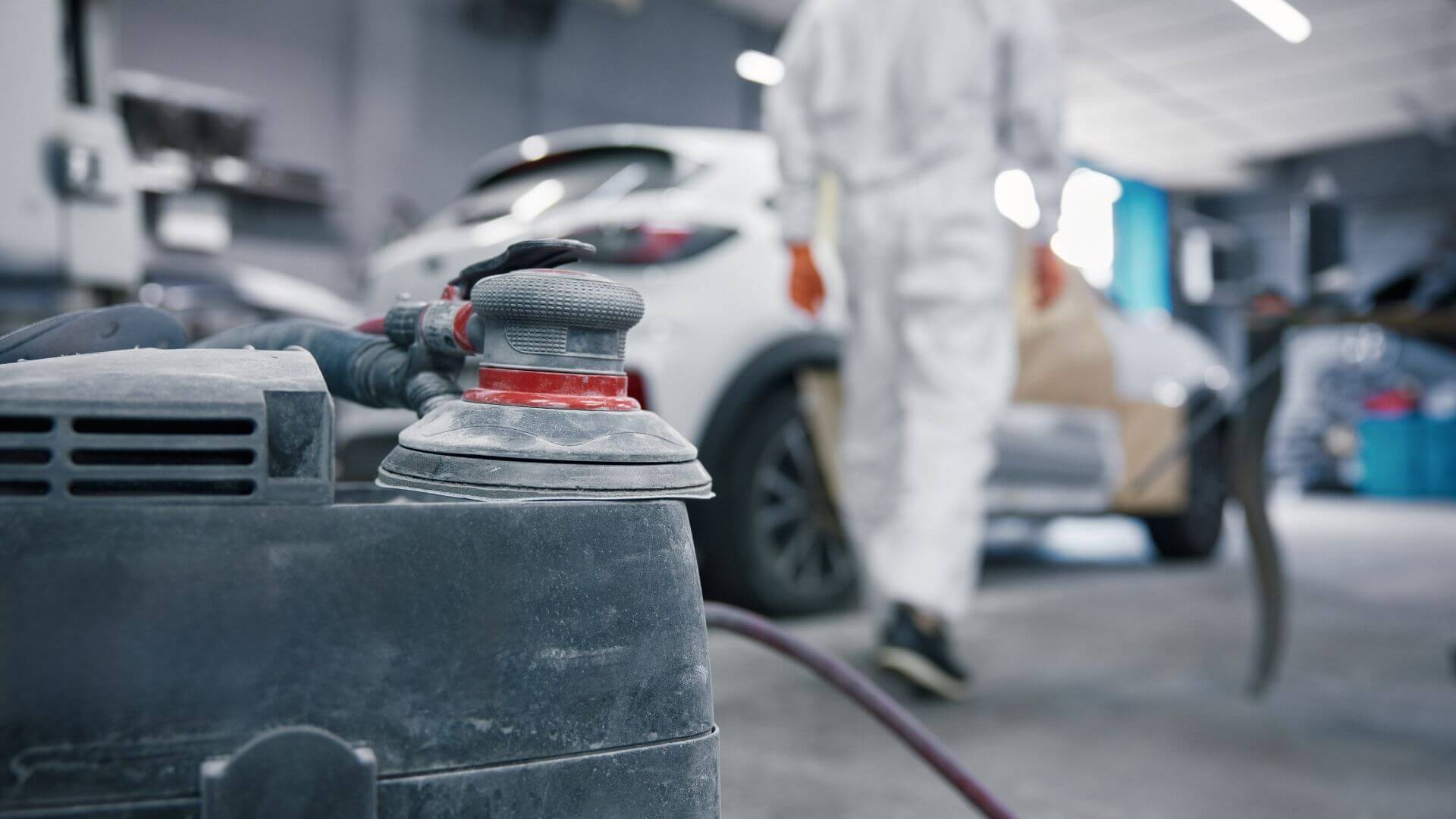 Auto body repair technician preparing vehicle for collision repair in Phoenix, AZ.